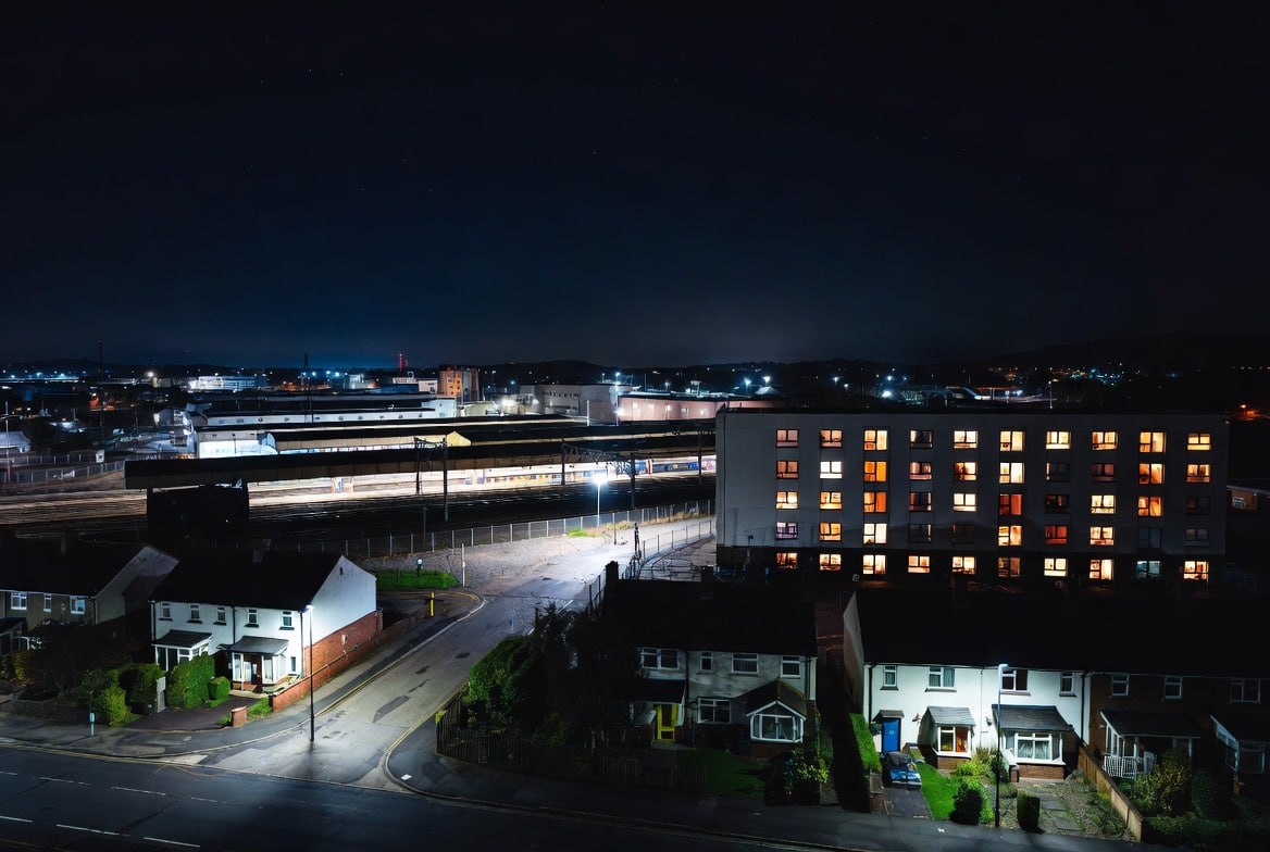 Railway at night with city lights